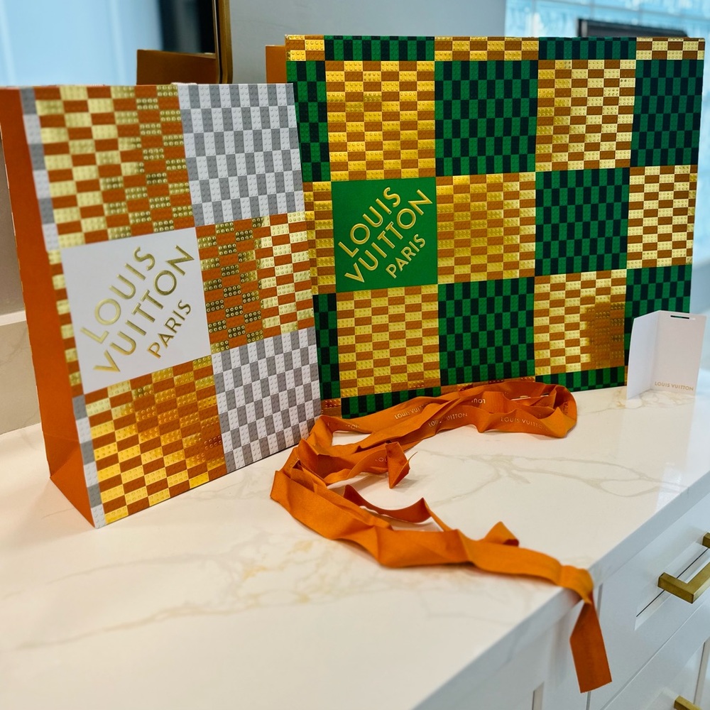 2 Louis Vuitton paper bags, slight tear (pictured). 19x16 in and 10x14 in.